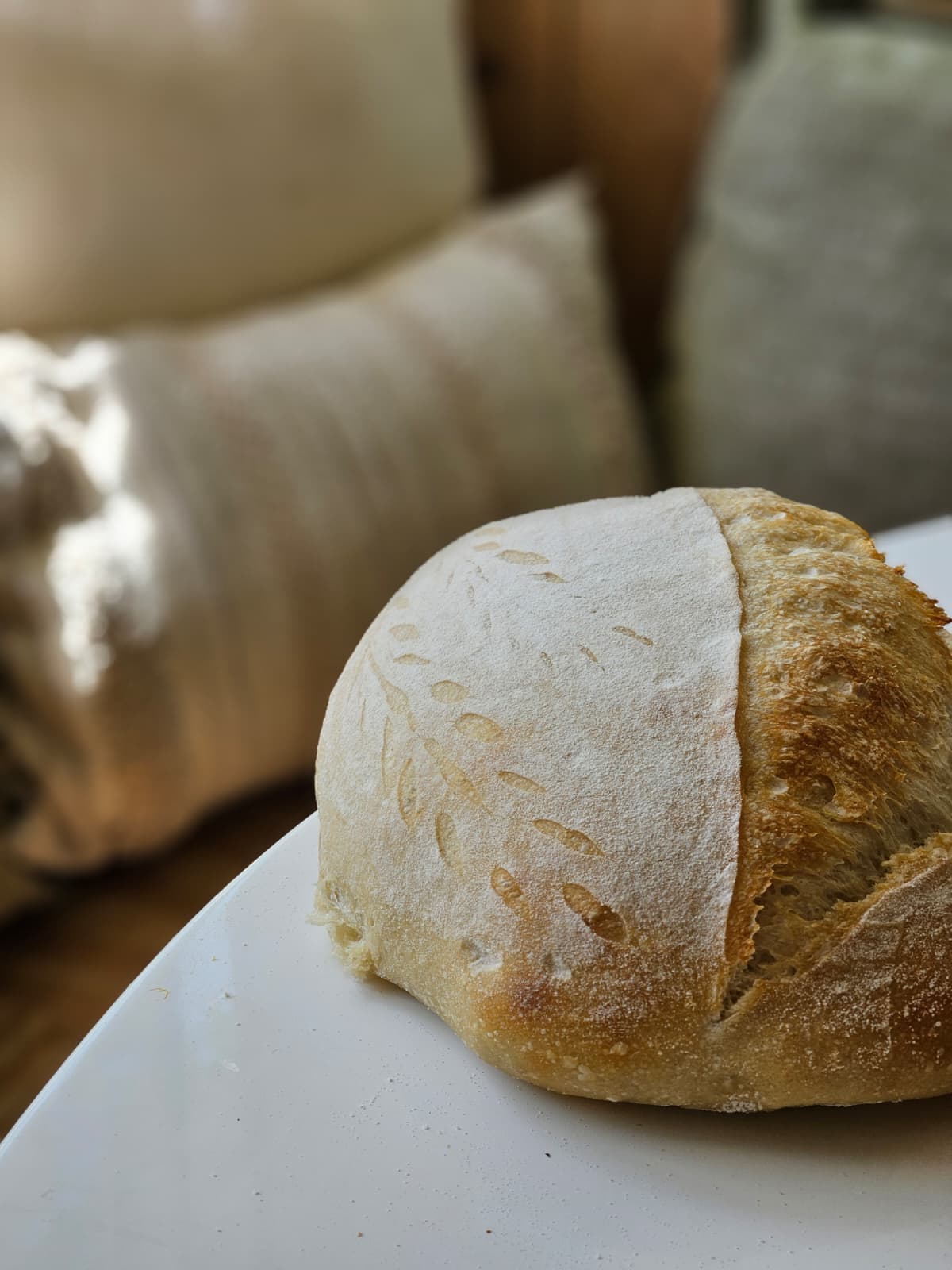 Single decorative sourdough loaf on a plate